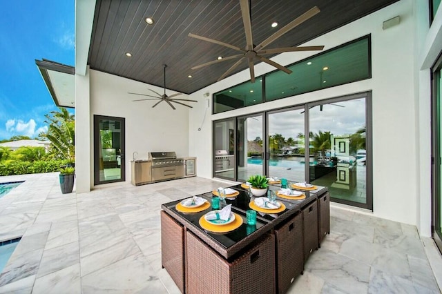 view of patio with ceiling fan, a grill, and area for grilling