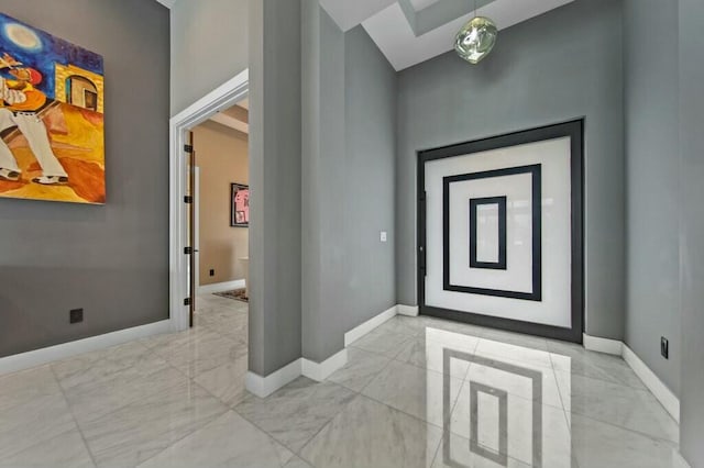 entryway featuring marble finish floor and baseboards