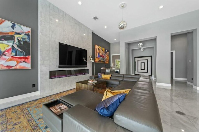 living area with baseboards, visible vents, a tile fireplace, marble finish floor, and recessed lighting