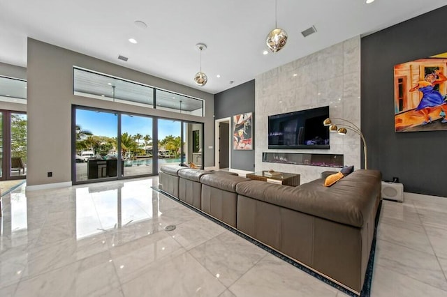 living room featuring marble finish floor, visible vents, and baseboards