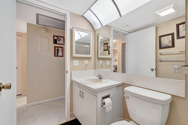 bathroom with tile patterned floors, vanity, and toilet