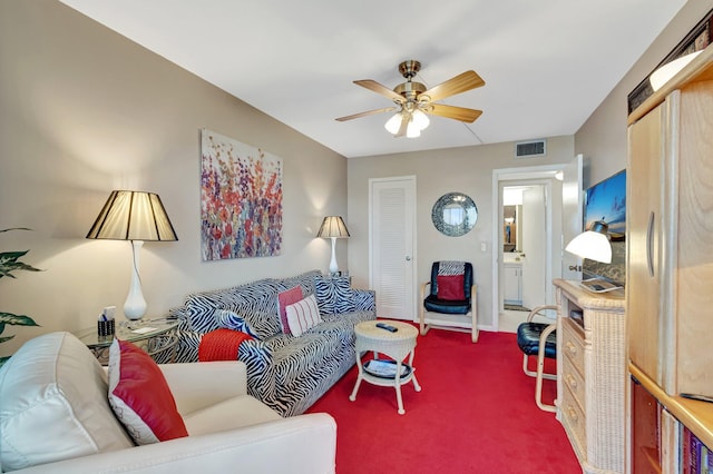 carpeted living room with ceiling fan