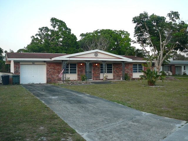 ranch-style home with a garage and a front yard