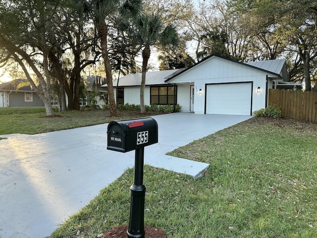 ranch-style home with a garage and a front lawn