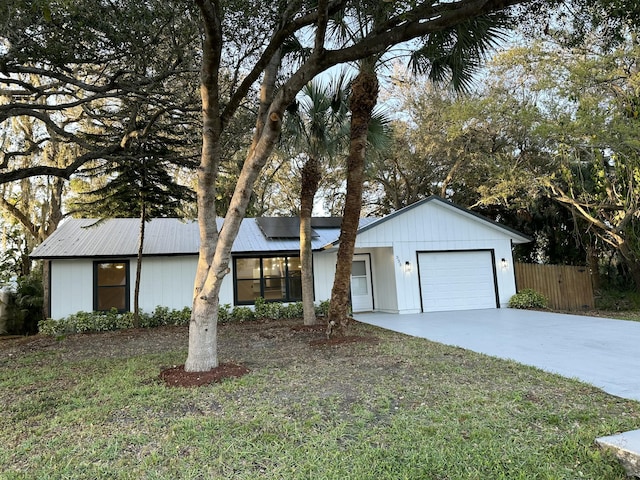 view of front facade featuring a garage and a front lawn