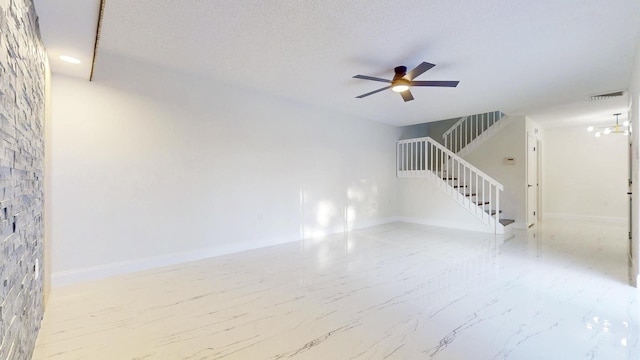 interior space with baseboards, a textured ceiling, stairway, and a ceiling fan