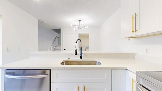 kitchen with dishwasher, light countertops, a sink, and white cabinets