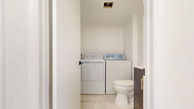 bathroom with washer and clothes dryer, vanity, and toilet