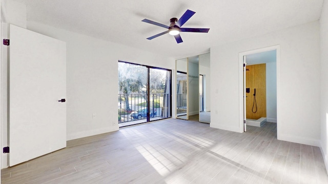 unfurnished bedroom featuring baseboards, a ceiling fan, light wood-style flooring, and access to exterior