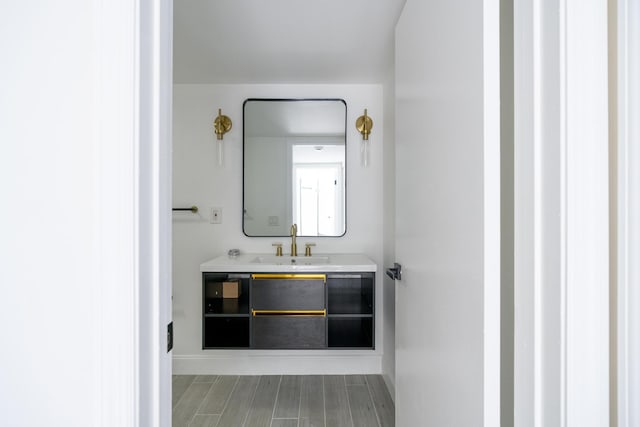 bathroom with wood finished floors and vanity