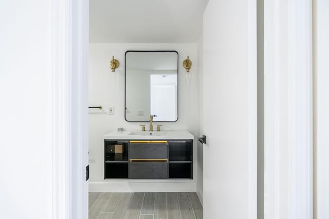 bathroom with wood finished floors and vanity