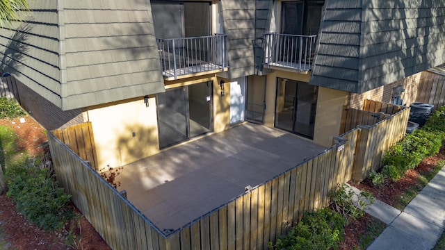 exterior space featuring central air condition unit and fence