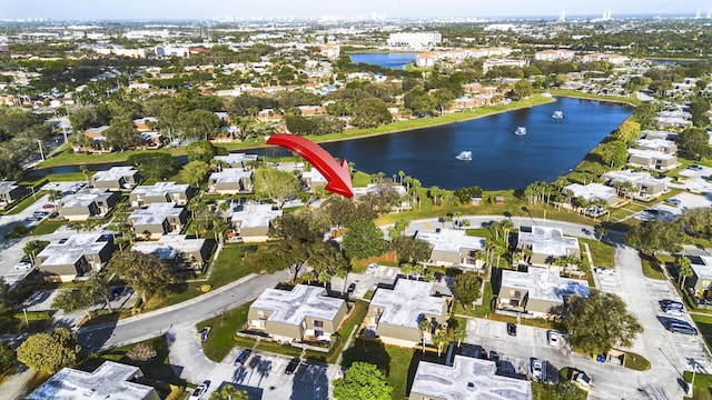 drone / aerial view with a water view and a residential view