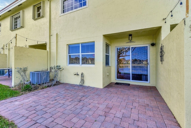 exterior space featuring central AC unit and a patio