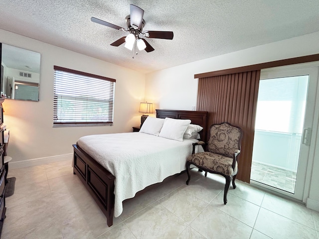 bedroom with ceiling fan, a textured ceiling, and light tile patterned floors