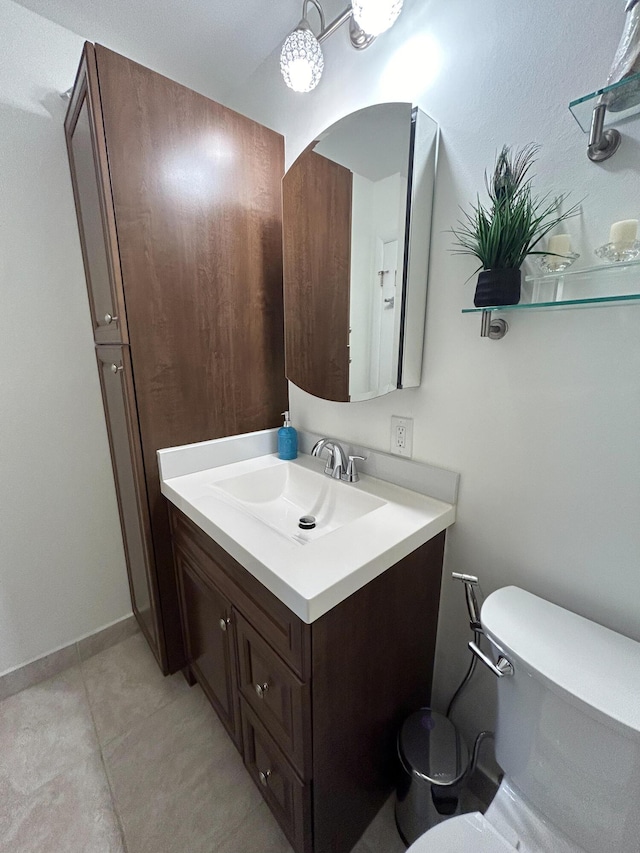 bathroom with tile patterned floors, vanity, and toilet