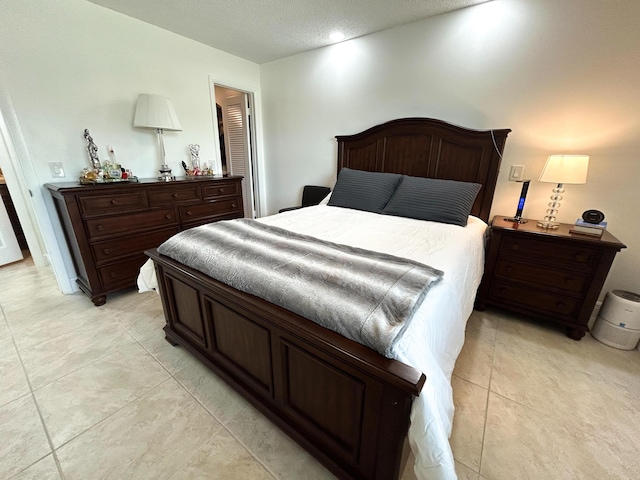 tiled bedroom with a textured ceiling