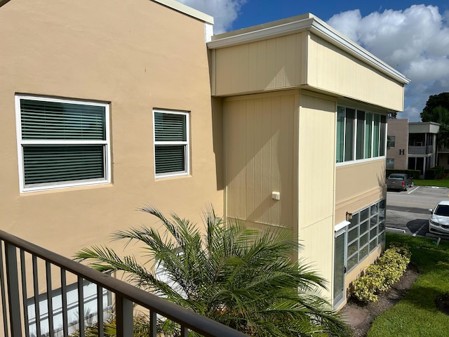 view of side of property with a balcony