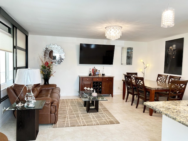 living room featuring a notable chandelier and light tile patterned floors