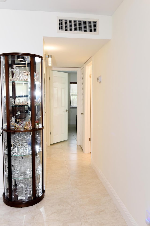 corridor with light tile patterned floors