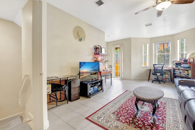 living area featuring a ceiling fan, visible vents, baseboards, and light tile patterned floors