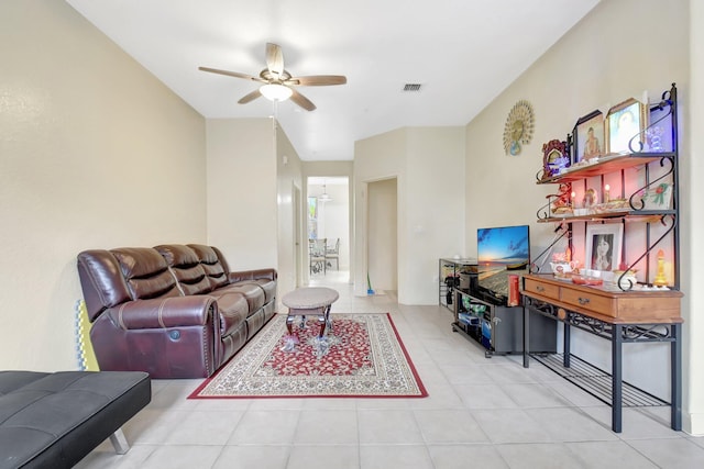living room featuring light tile patterned floors, visible vents, and a ceiling fan
