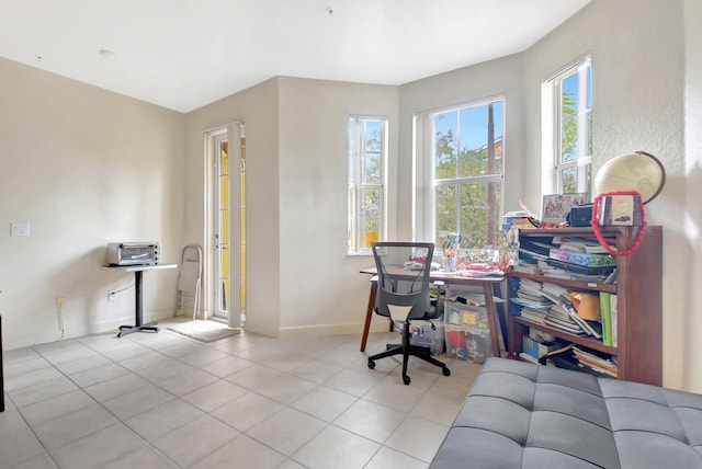 office space featuring light tile patterned flooring and baseboards