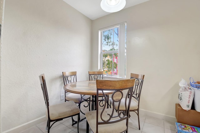 dining room featuring light tile patterned floors and baseboards