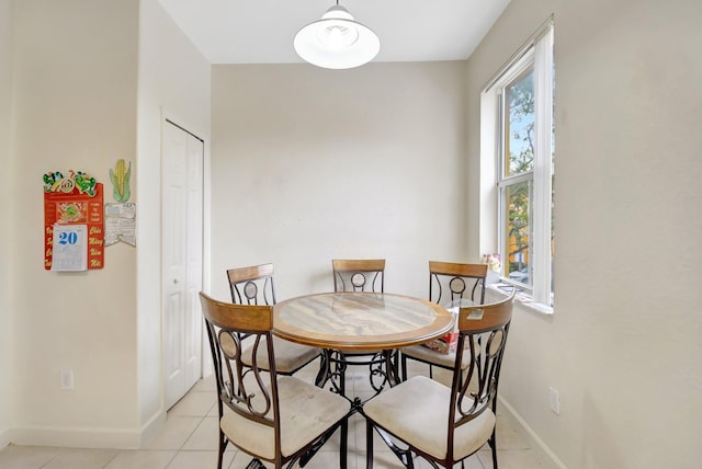 dining room featuring baseboards and light tile patterned floors