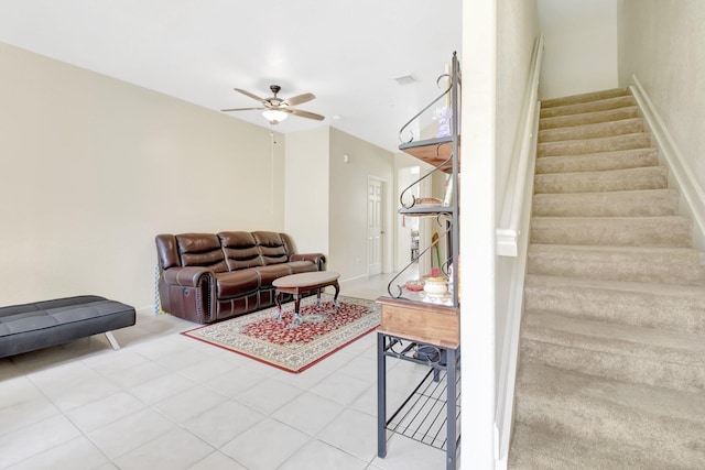 living area with ceiling fan, stairs, and visible vents