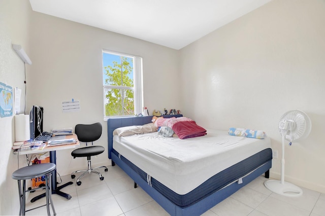 tiled bedroom featuring baseboards