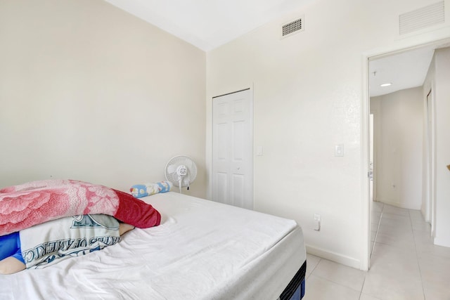 bedroom with light tile patterned floors, baseboards, and visible vents
