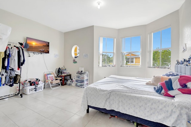 tiled bedroom featuring multiple windows