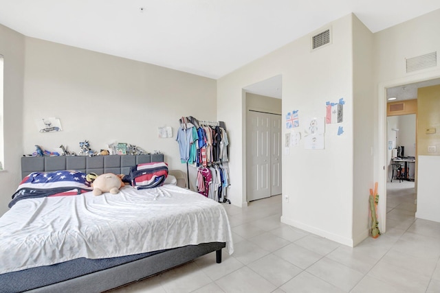 bedroom with light tile patterned flooring, visible vents, and baseboards
