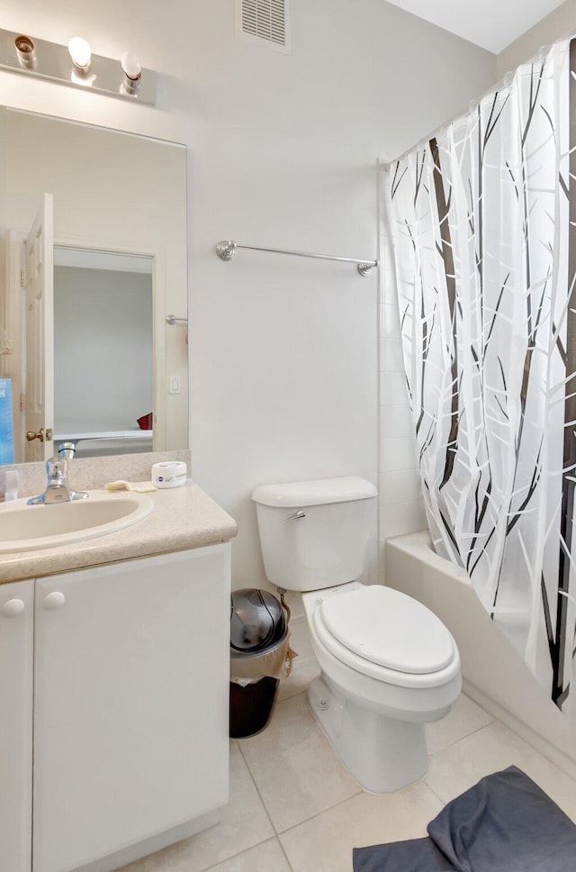 bathroom featuring tile patterned flooring, visible vents, shower / tub combo with curtain, and toilet
