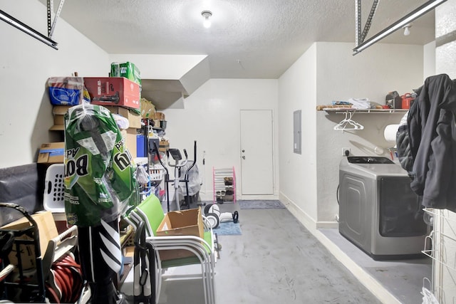 garage featuring washer / dryer, electric panel, and baseboards