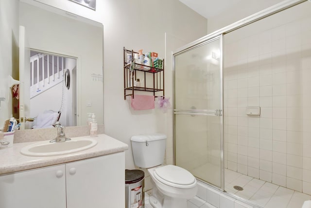 full bath with a stall shower, vanity, and toilet