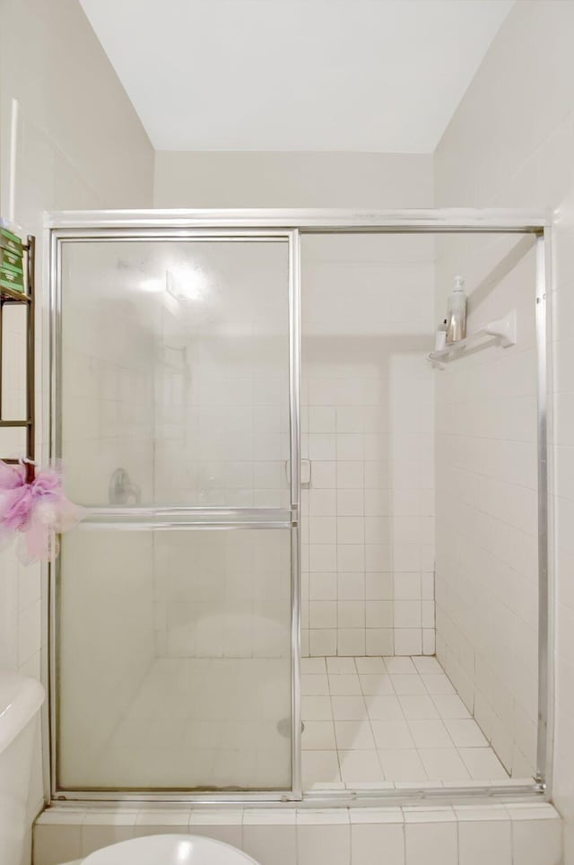 full bath with a shower stall and toilet