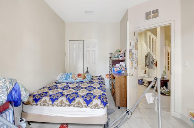 bedroom with tile patterned flooring, a closet, and visible vents