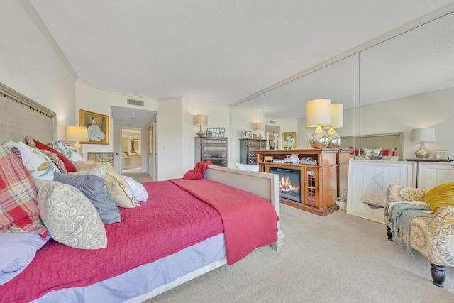 carpeted bedroom featuring crown molding and a textured ceiling