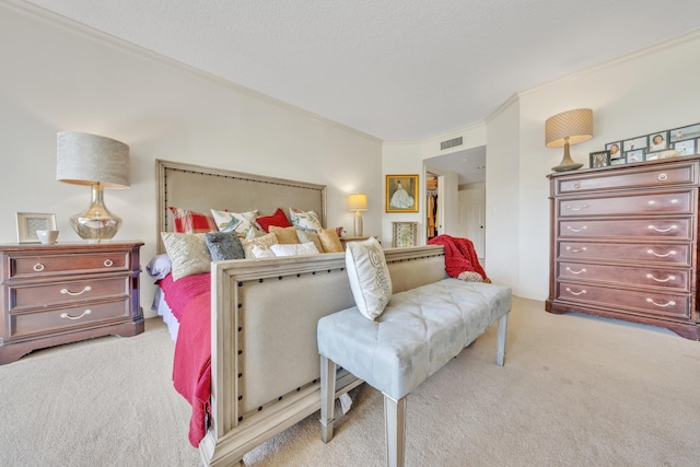 bedroom featuring ornamental molding, light carpet, and a textured ceiling