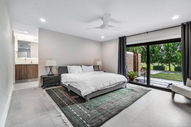 bedroom with ceiling fan, ensuite bath, and access to outside