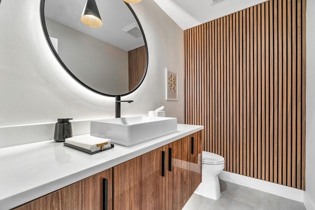 bathroom with vanity, tile patterned floors, and toilet