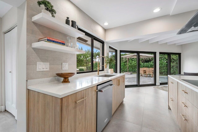 kitchen featuring light brown cabinetry, sink, light tile patterned floors, stainless steel dishwasher, and backsplash