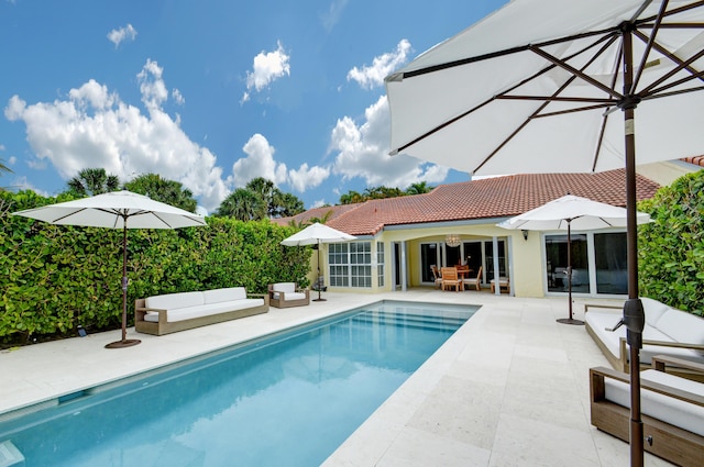 outdoor pool featuring an outdoor hangout area and a patio