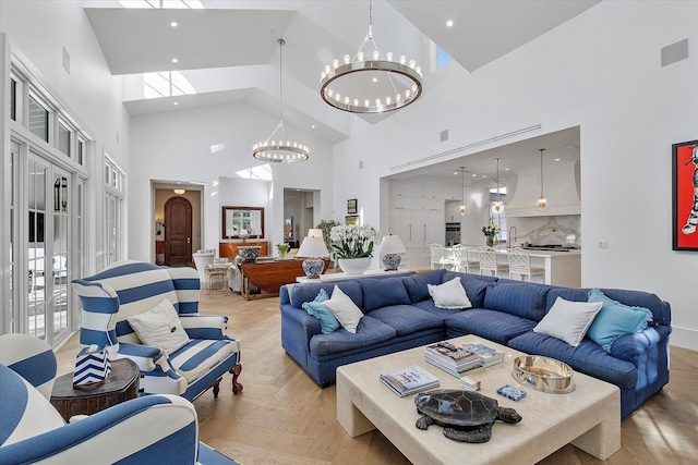 living room featuring light parquet floors, a chandelier, and a towering ceiling