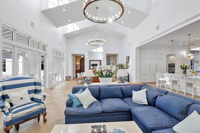 living room featuring a notable chandelier and light parquet flooring