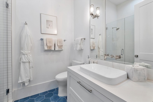 bathroom featuring vanity, toilet, an enclosed shower, and tile patterned flooring