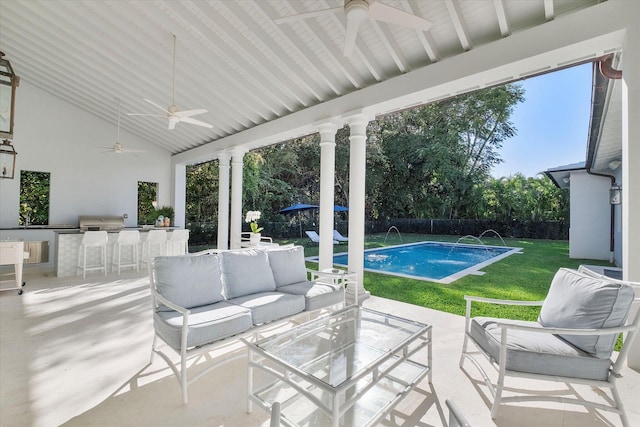 view of patio / terrace with pool water feature, outdoor lounge area, a bar, ceiling fan, and a fenced in pool