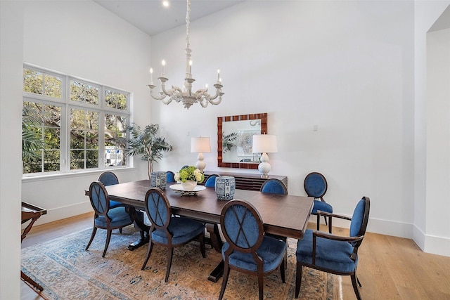 dining space with a chandelier and light hardwood / wood-style flooring